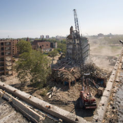 A mid-rise building being demolished